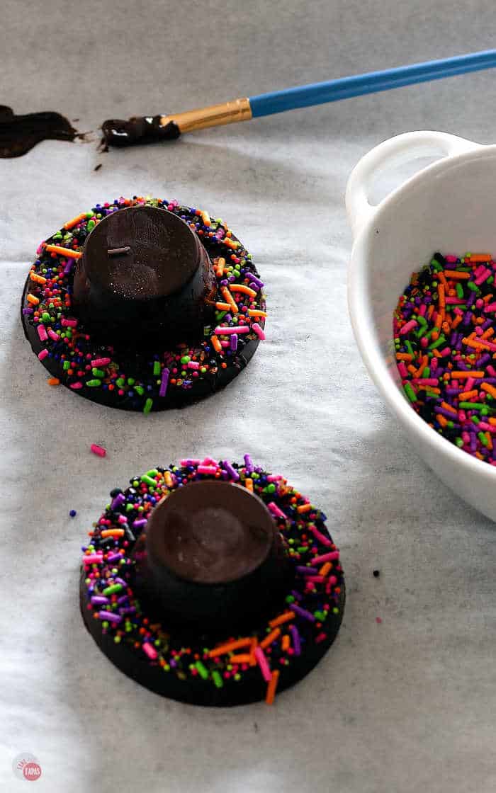 picture of adding sprinkles to the chocolate peanut butter hats