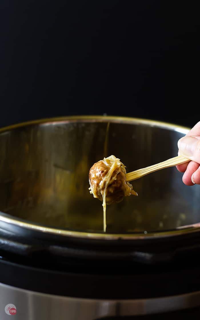 picture of pulling a meatball out of the instant pot