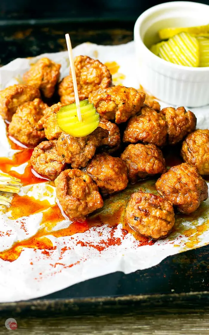 picture of hot chicken meatballs and pickles on toothpicks