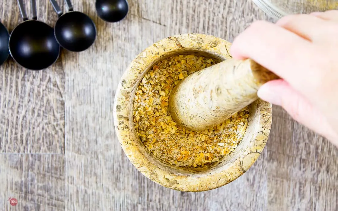 adobo seasoning ingredients in a mortar and pestle