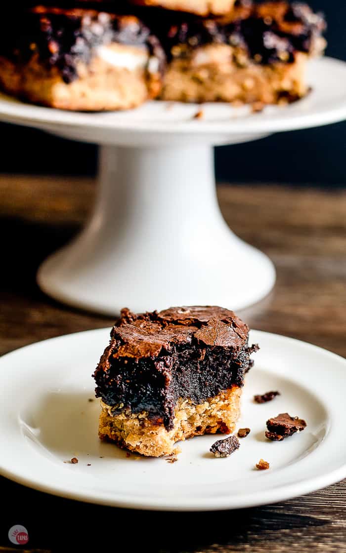 peanut butter Oreo brownie on white plate with a bite taken out of it