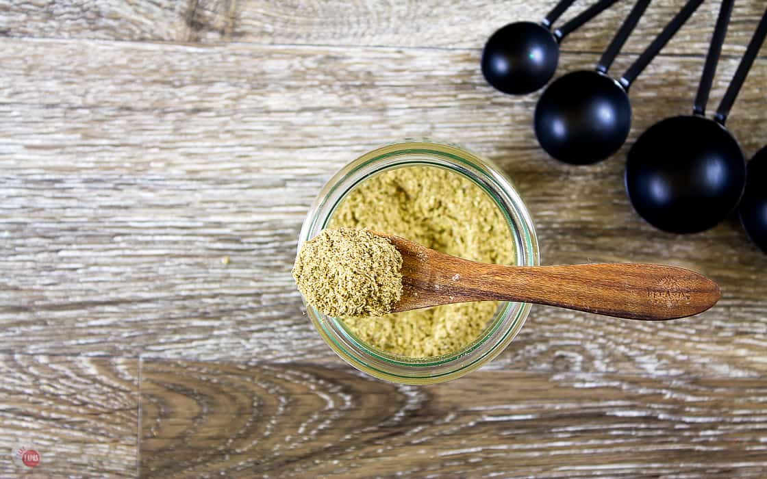 overhead picture of seasoning in a wood spoon on top of a jar