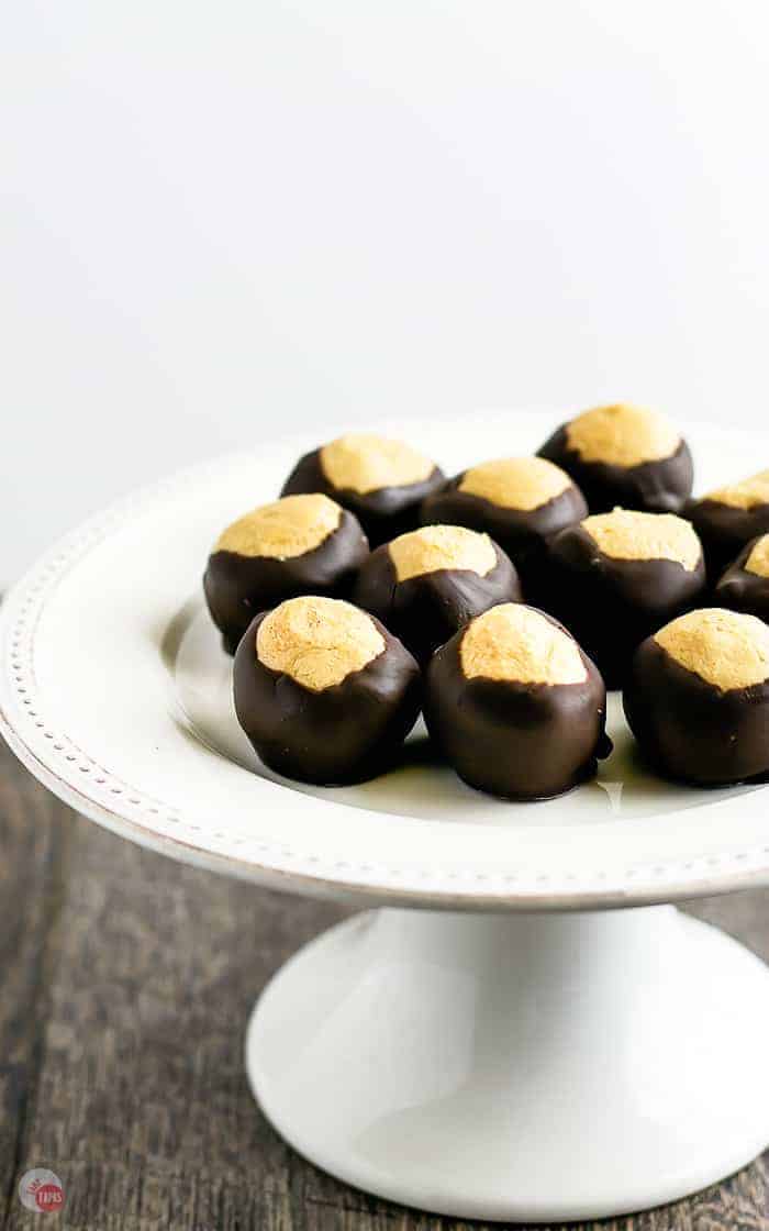 white pedestal platter with peanut butter buckeyes on top