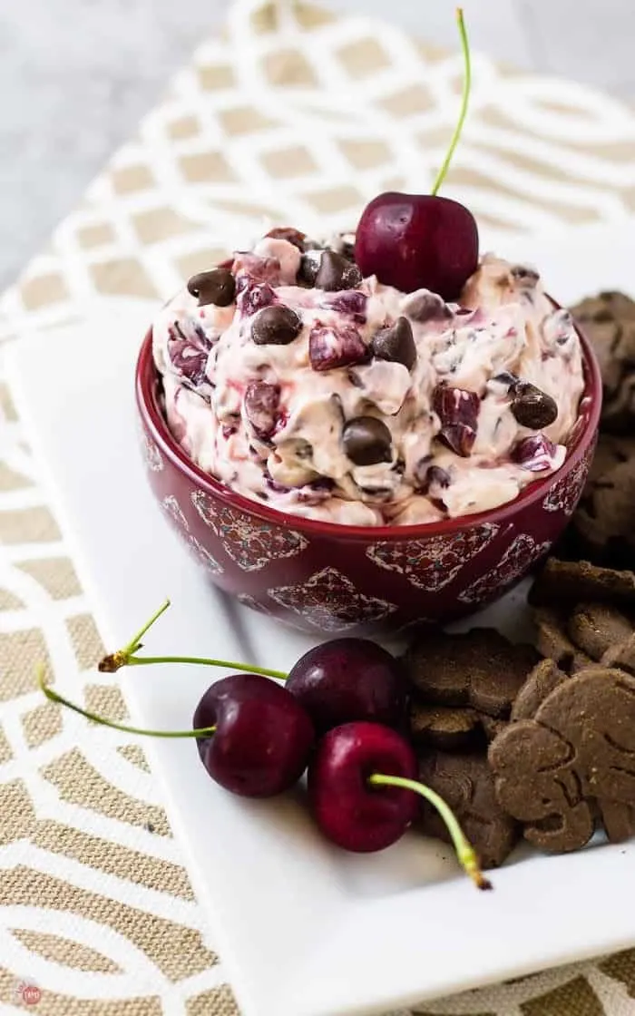 side view of platter of chocolate cherry dip and fresh cherrries
