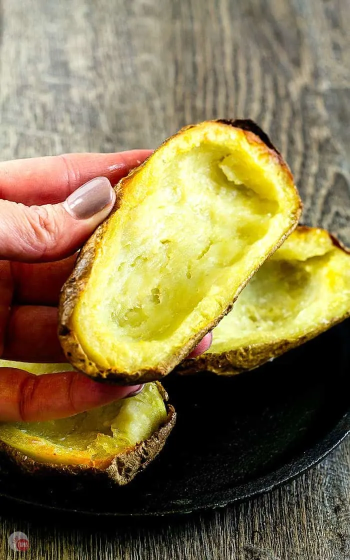 hand holding a plain crispy baked potato skin