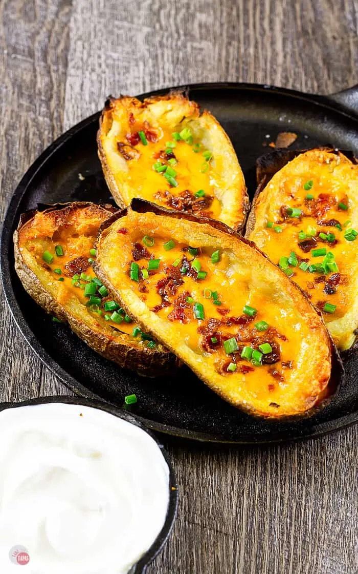 cast iron skillet with four potato boats