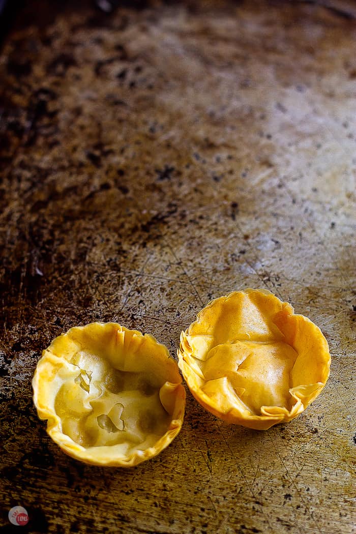 two phyllo cups on a baking pan