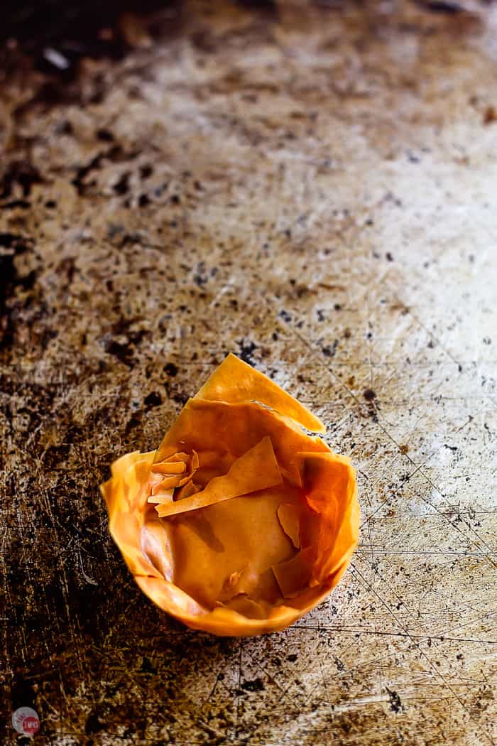 overcooked pastry cup on a baking sheet