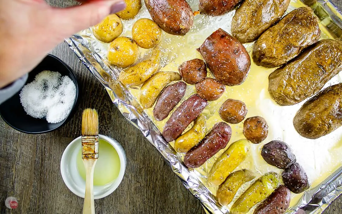 potatoes cut side down being sprinkled with salt