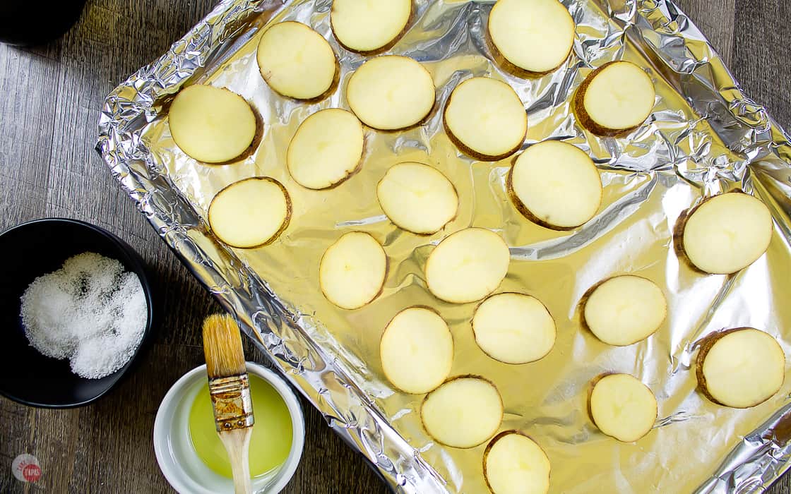 potato slices arranged on a baking sheet