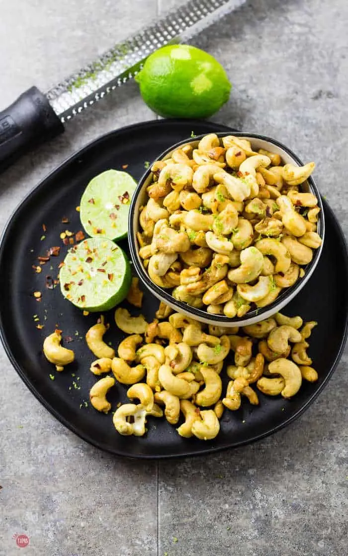 overhead view of spicy cashews and limes