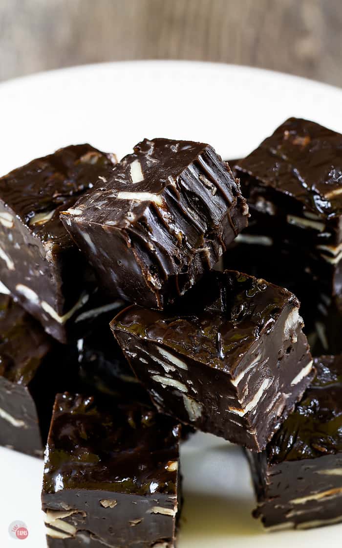 pile of small pieces of dark chocolate fudge on a white plate