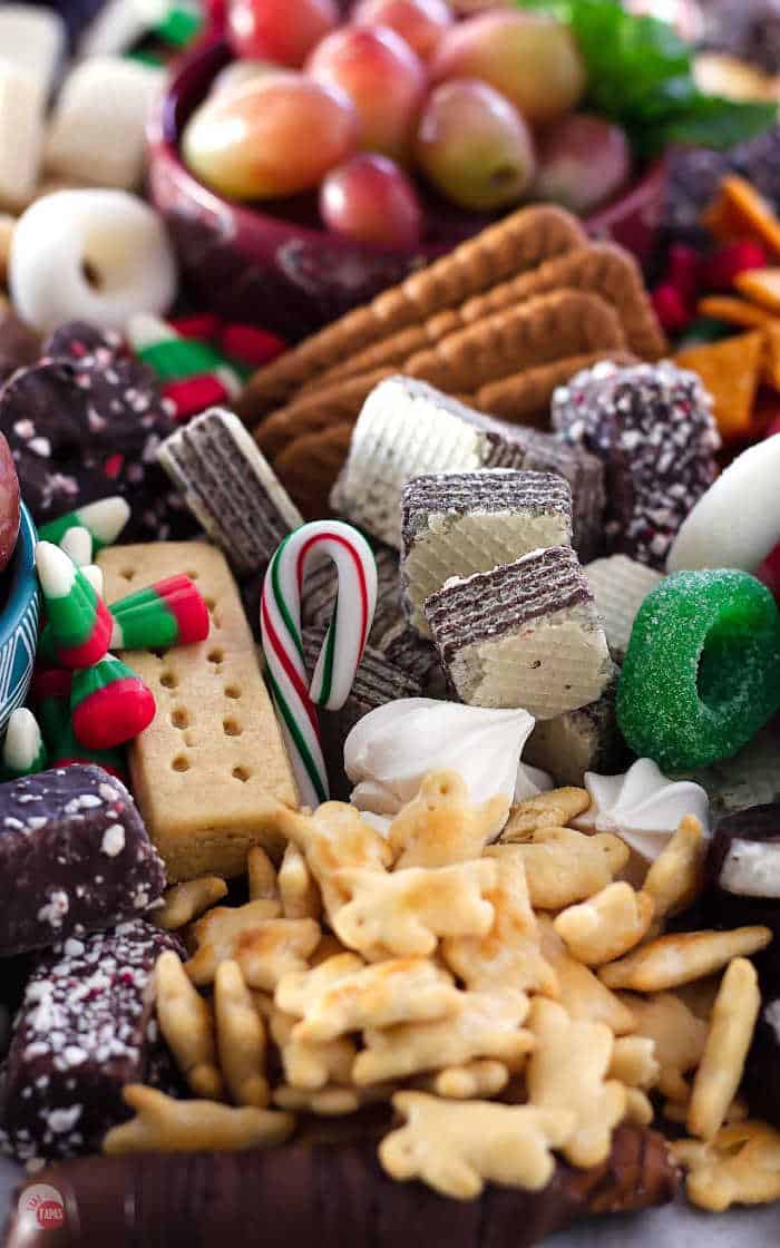 candy canes and cookies on a board