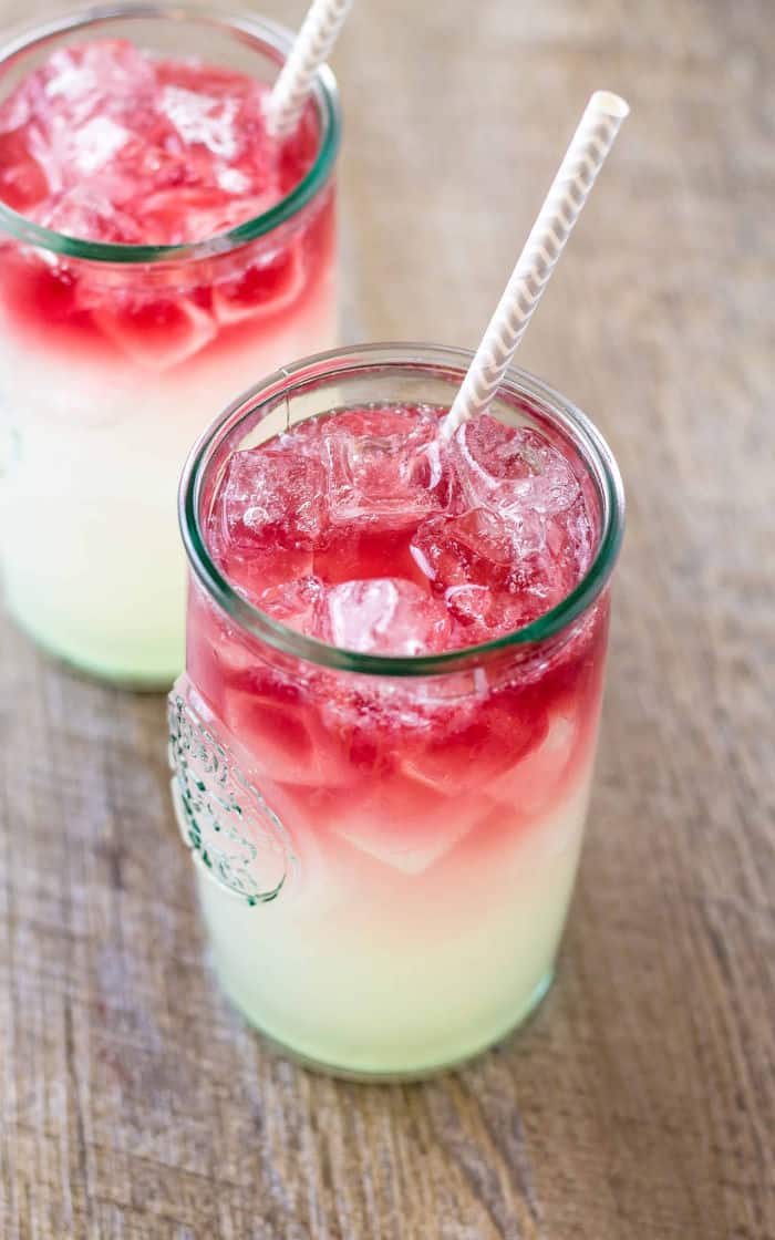 Two glasses of wine cocktails with straws