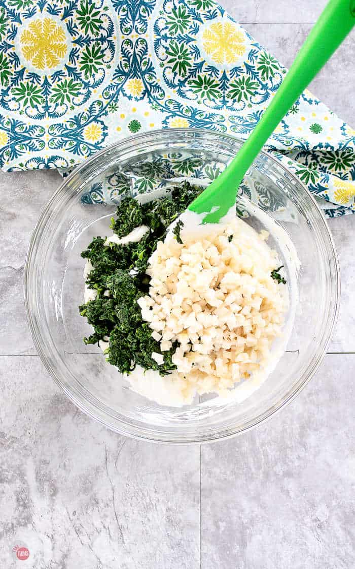 spinach and water chestnuts in a bowl with dip