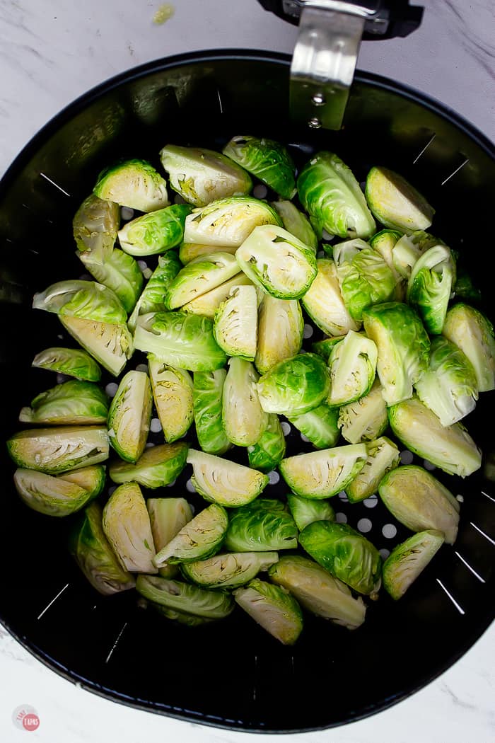 seasoned raw sprouts in air fryer basket