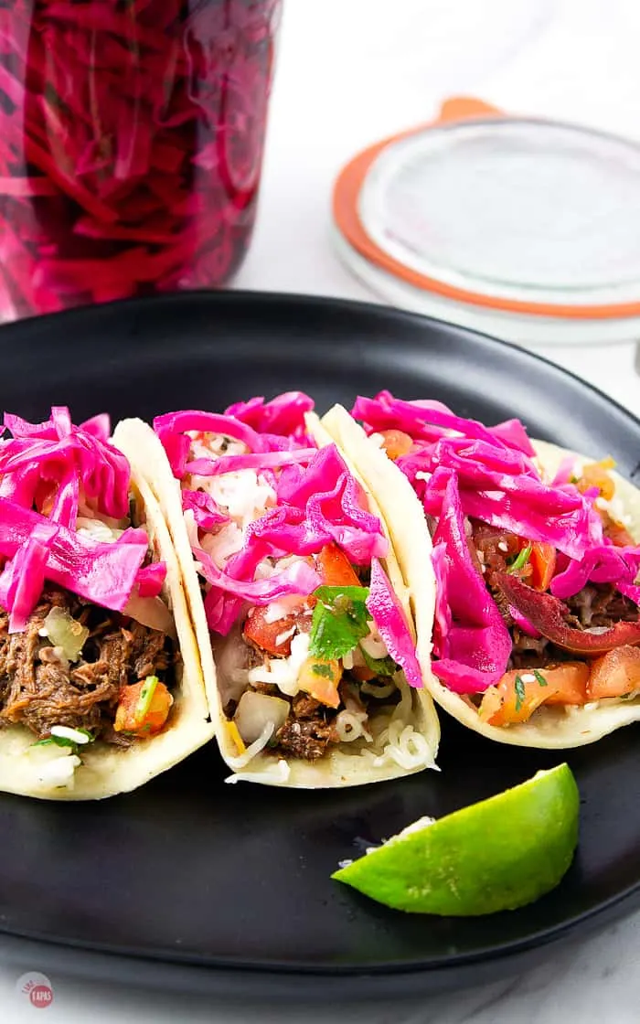 Pickled red cabbage on 3 tacos