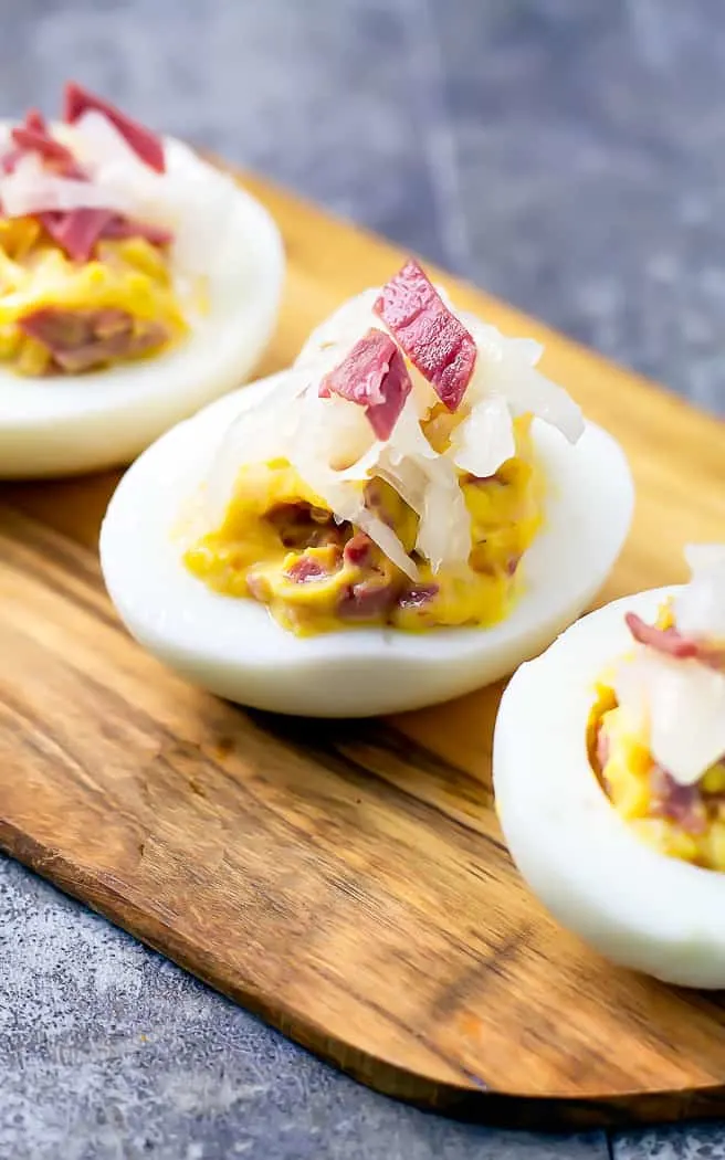 corned beef and sauerkraut in a deviled egg on wood platter