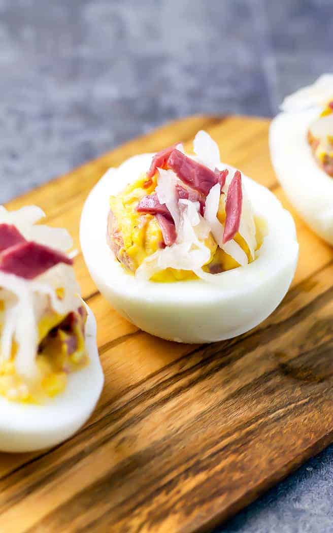 deviled egg with corned beef and kraut on it