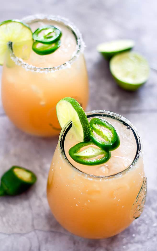 overhead picture of two cocktails with jalapeno slices as garnish