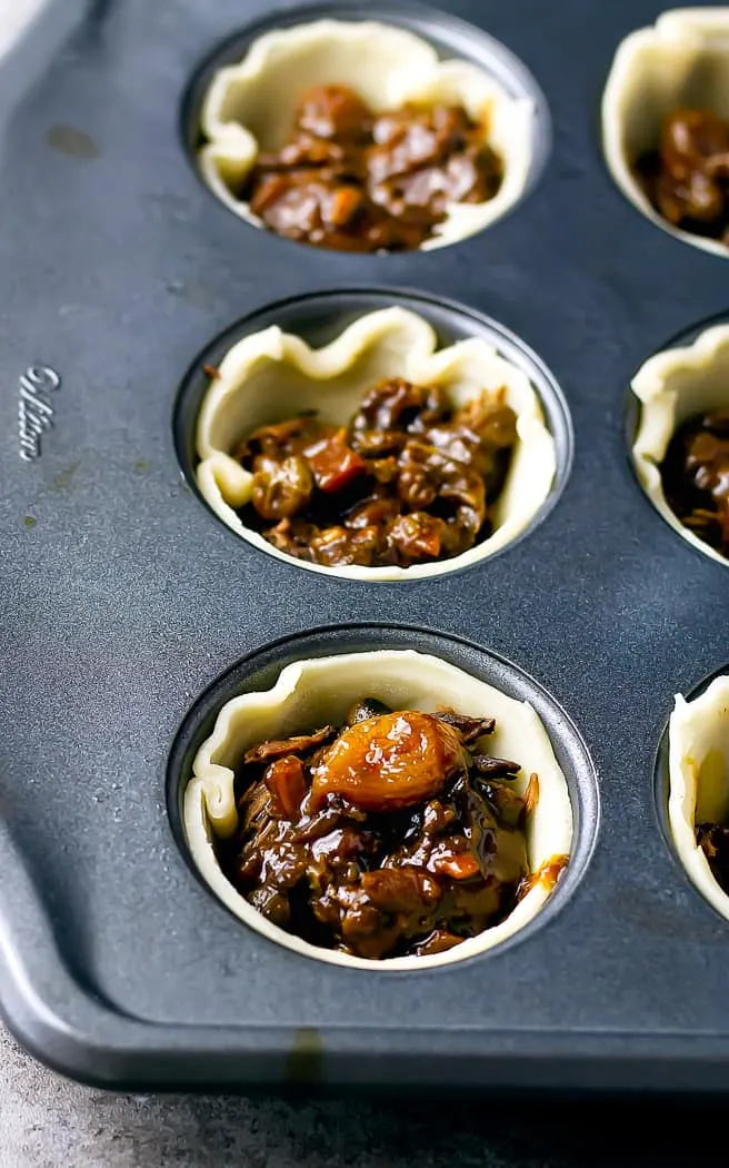 mini pie crusts with beef and sauce