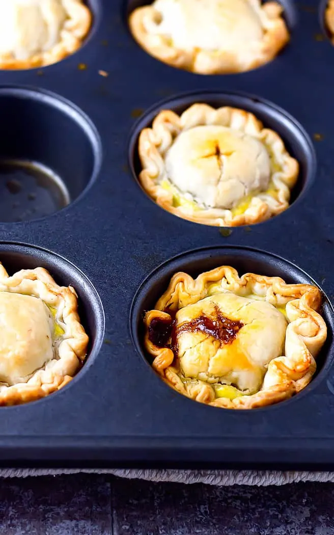 mini beef hand pies in a muffin tin