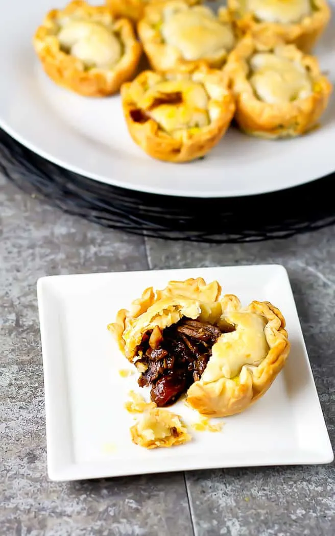 beef pie broken open on a while plate