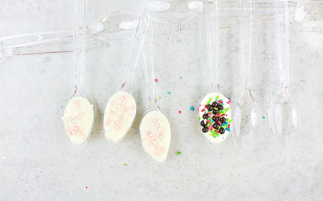 plastic spoons with white chocolate and toppings