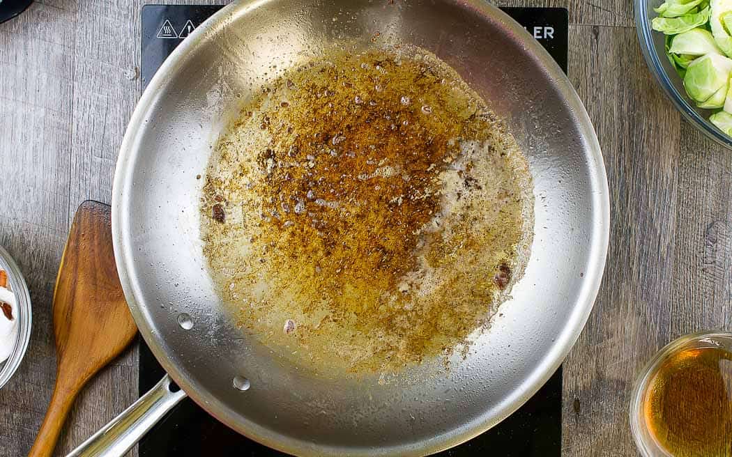 brown bits in pan with bourbon