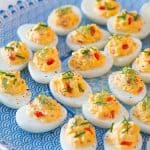 pimento cheese deviled eggs on a blue and white platter