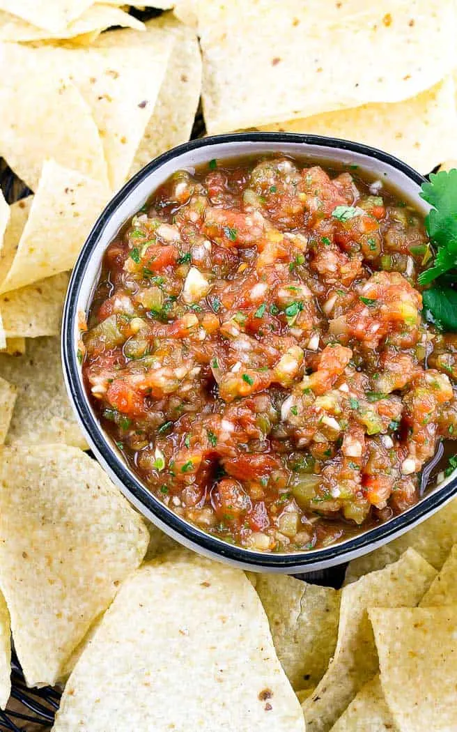 overhead picture of salsa in a bowl surrounded by chips