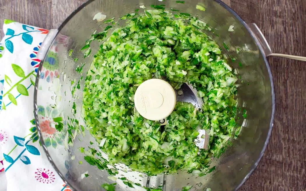 chopped ingredients in a processor bowl