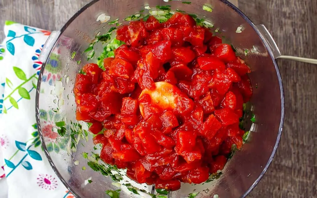 tomatoes and salsa ingredients in a bowl