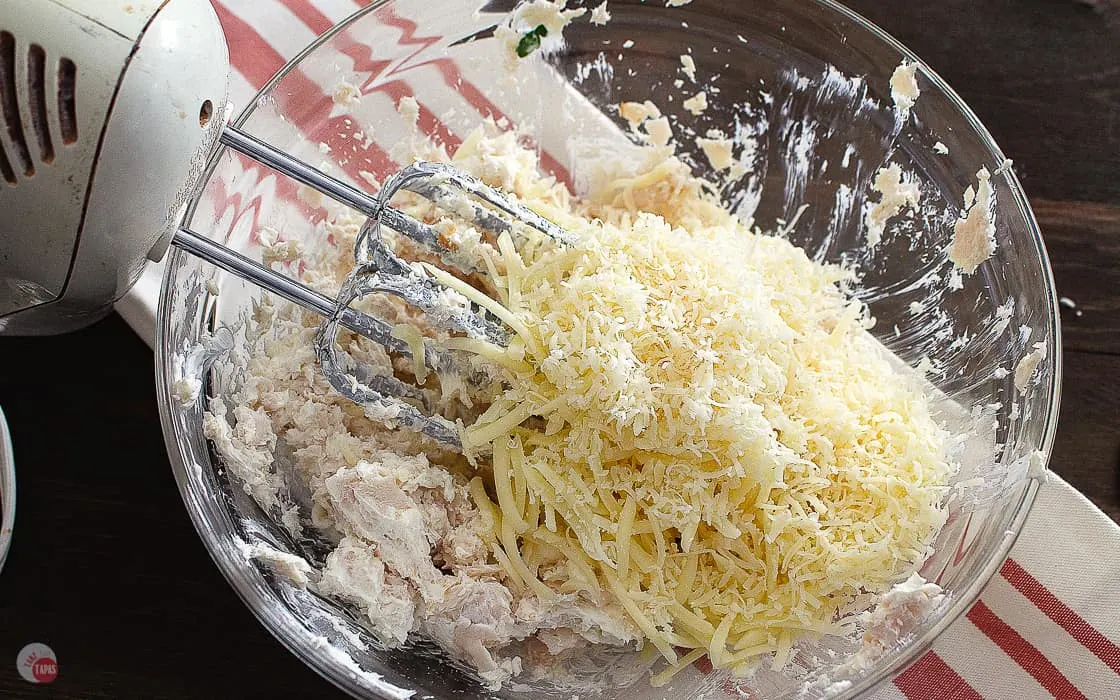 cheese added to turkey and cream cheese in a bowl