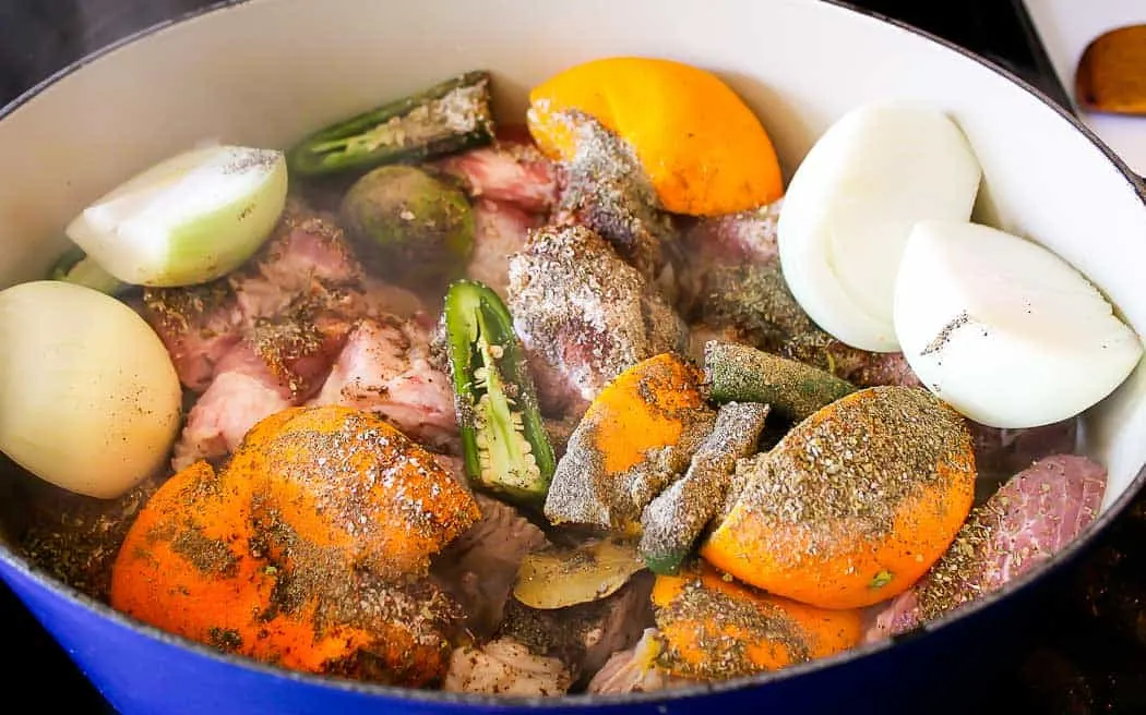 carnitas ingredients in a blue pot