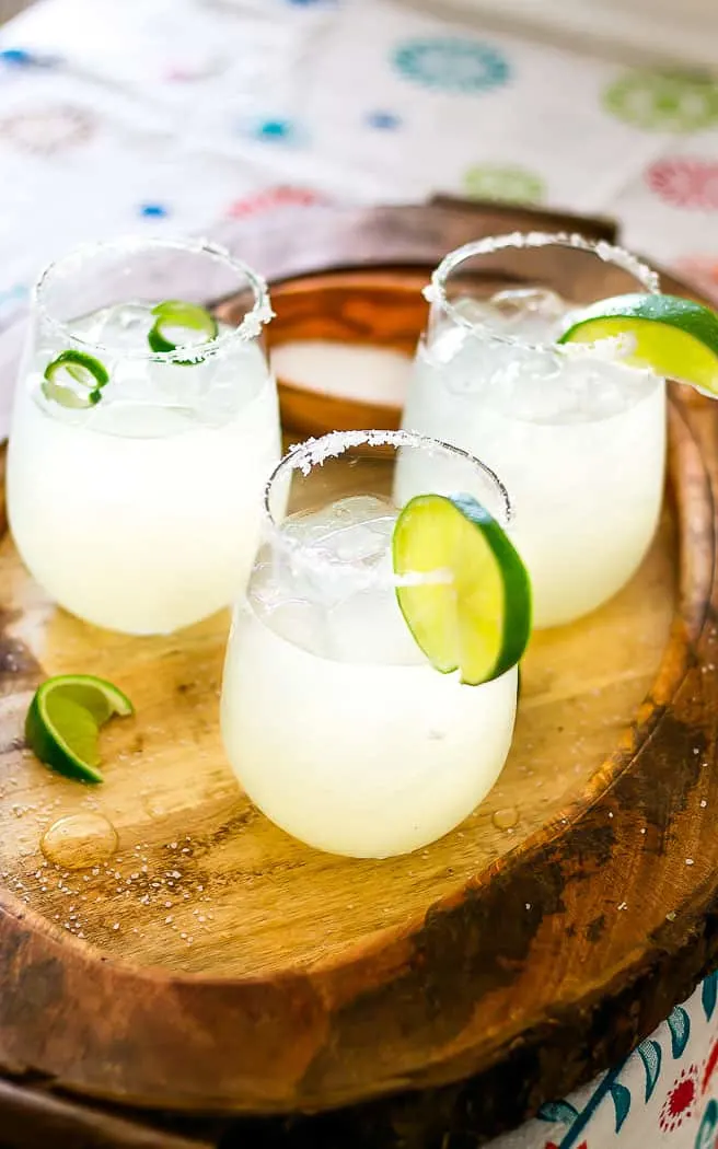 3 ingredients margarita in a glass with lime curls