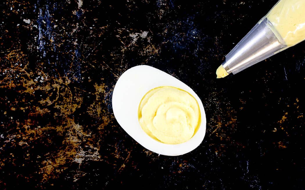 overhead picture of plain deviled egg on a baking sheet