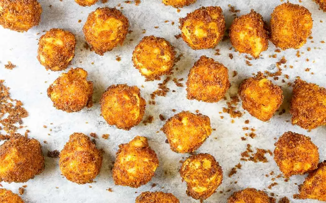 overhead picture of fried macaroni balls on a baking sheet