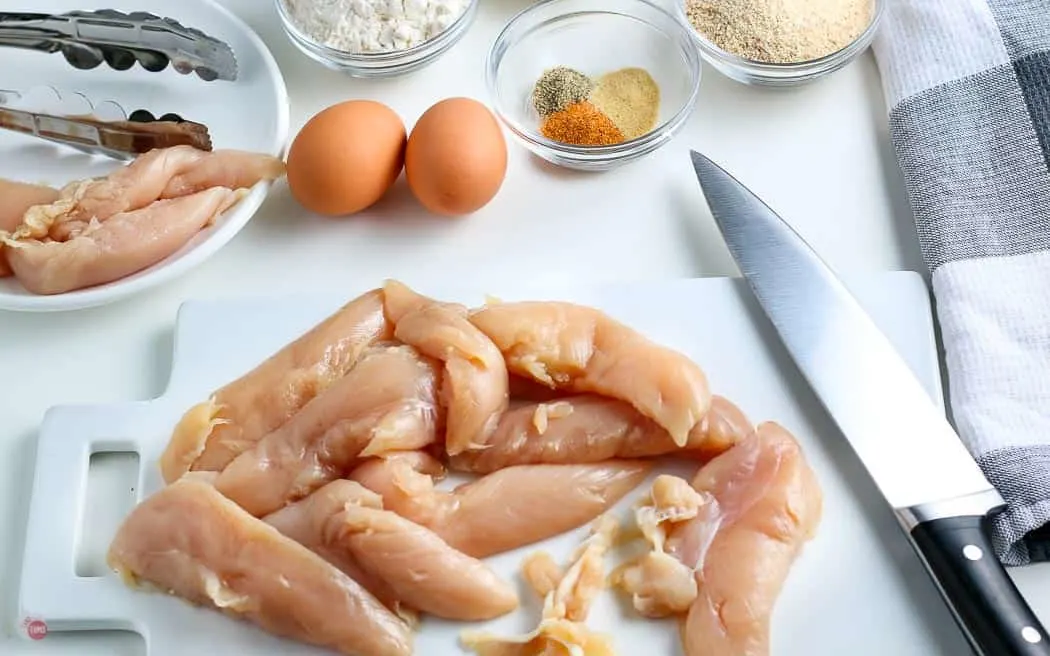 raw chicken tenders on a cutting board