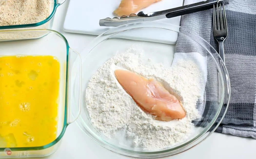 chicken tender in a bowl of flour