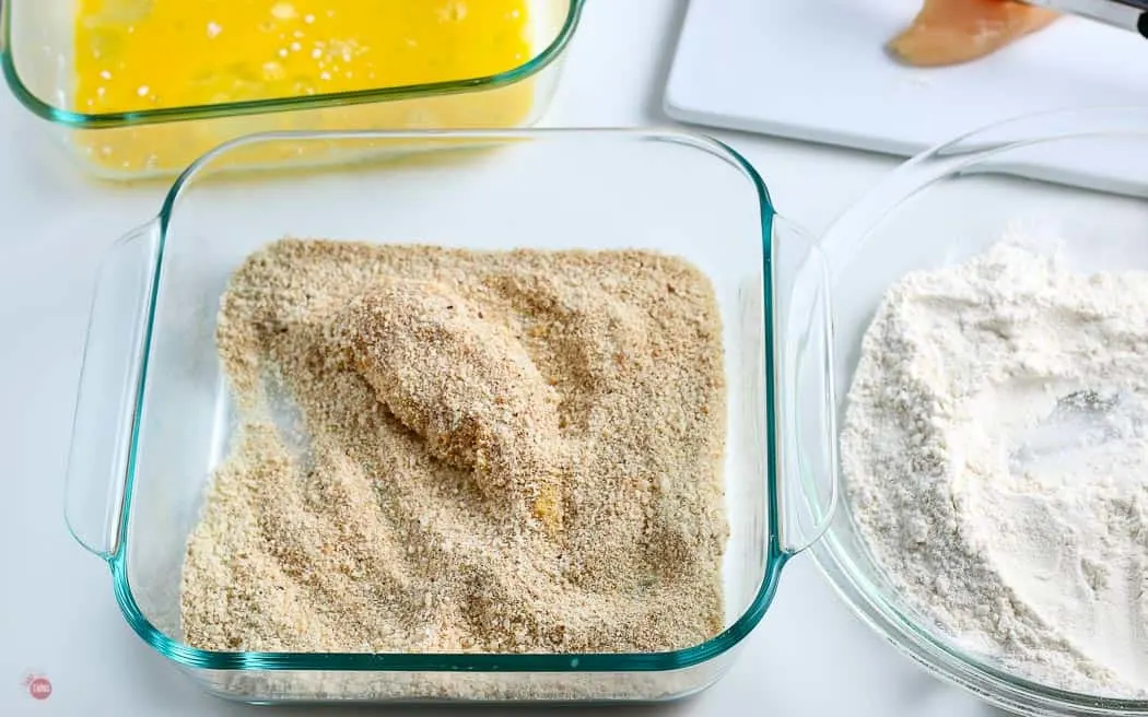 chicken tender in a bowl of breadcrumbs