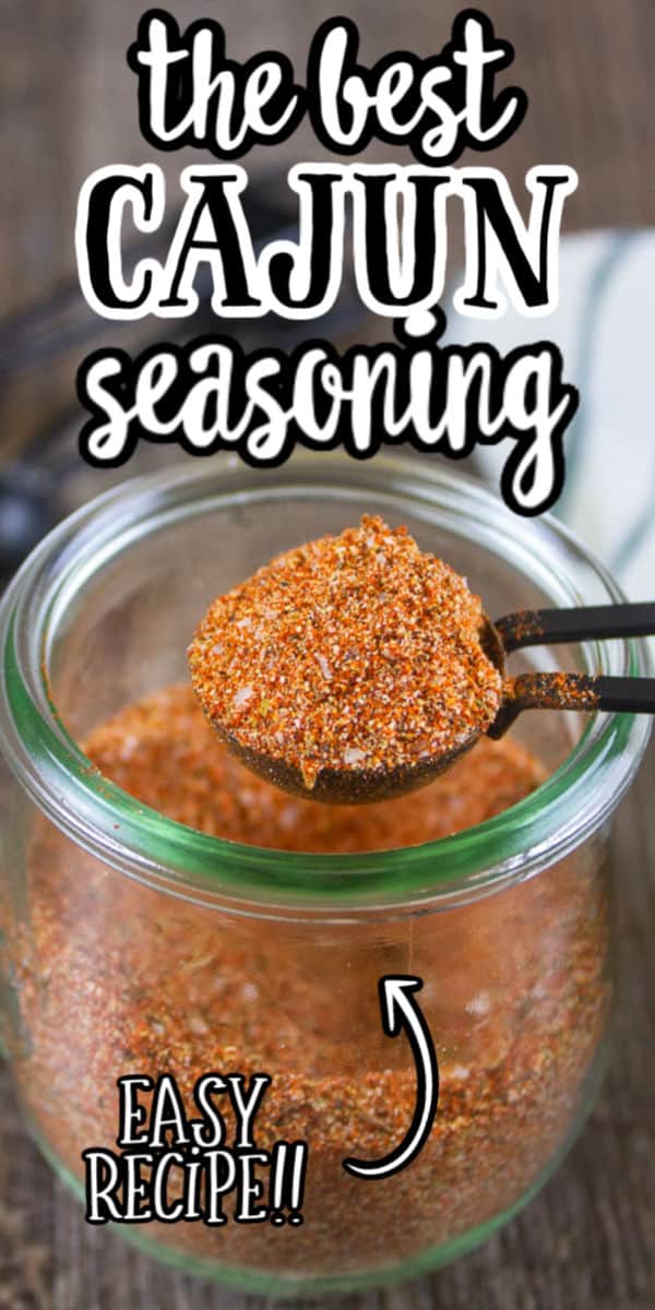 pinterest image of cajun seasoning in a clear jar with text "the best cajun seasoning - easy recipe"