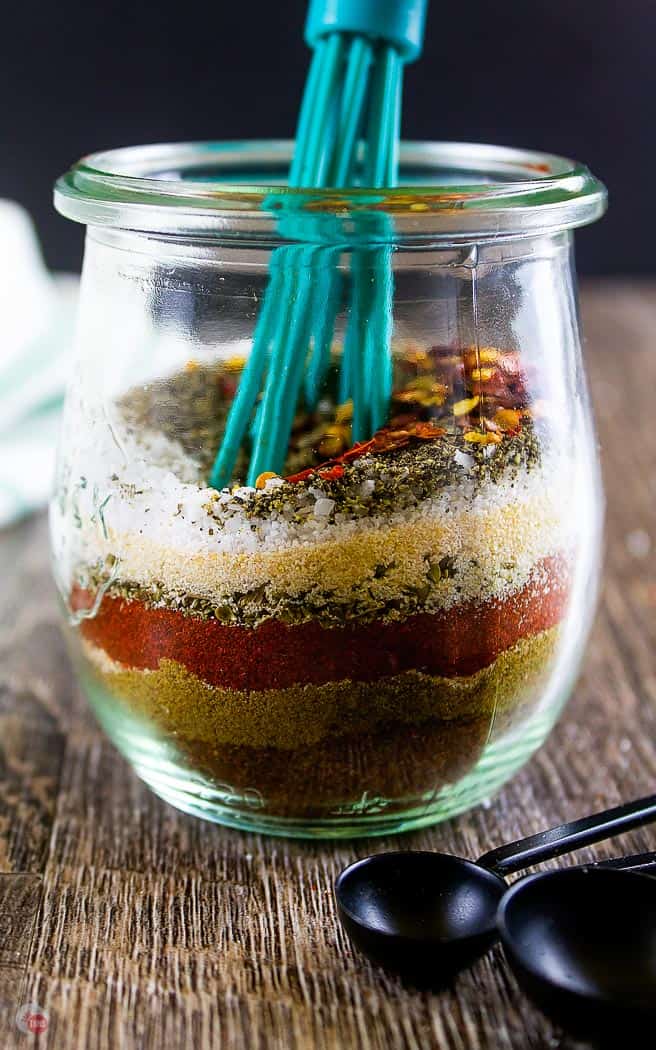 jar of layered spices with a whisk in it