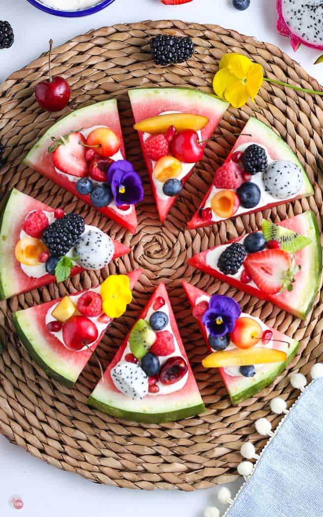 overhead picture of watermelon pizza on straw charger