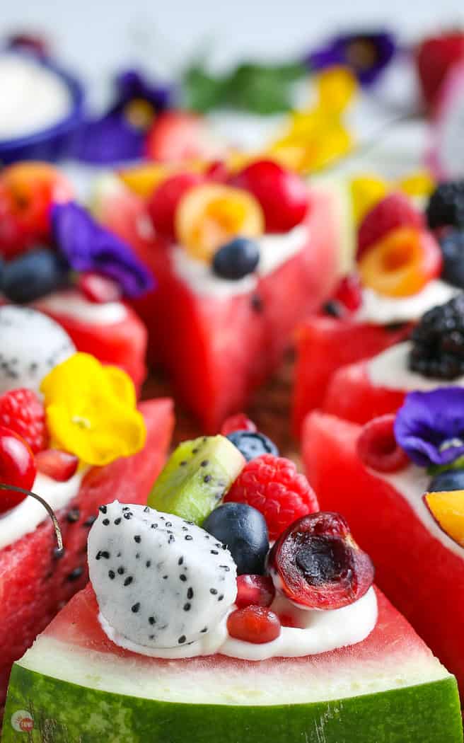 side close picture of slice of watermelon pizza topped with fruit