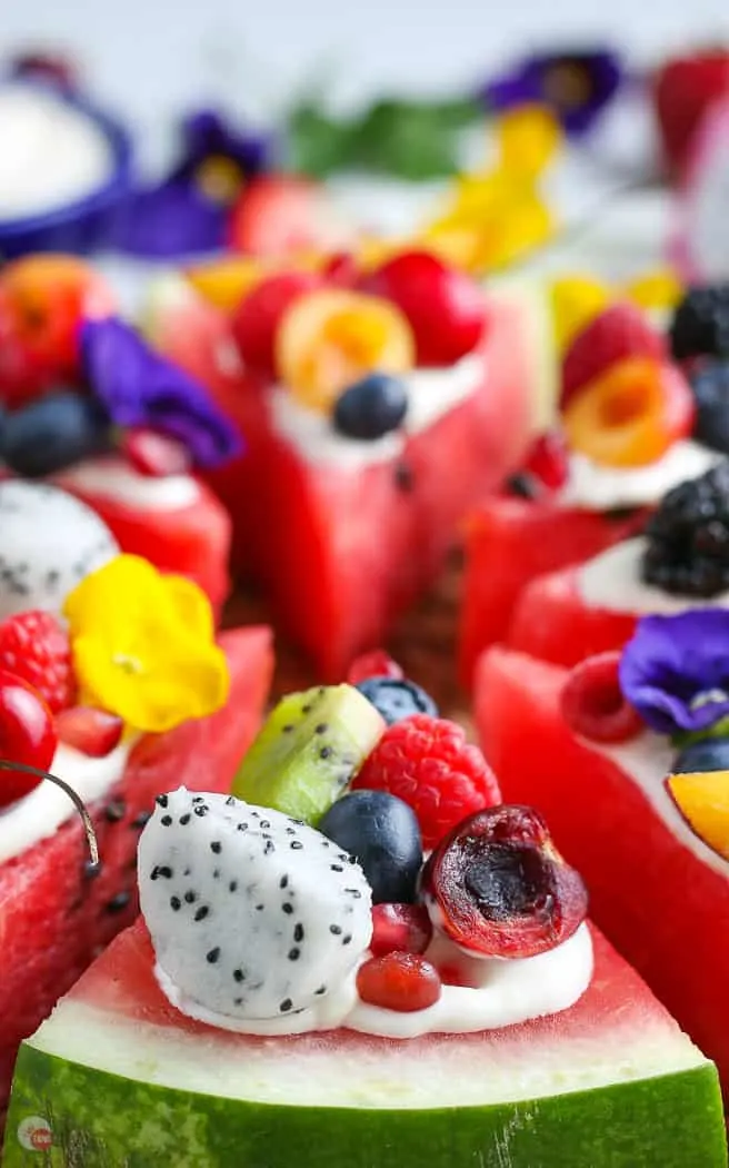 side close picture of slice of watermelon pizza topped with fruit