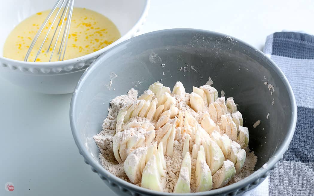 sliced onion in a bowl with breading