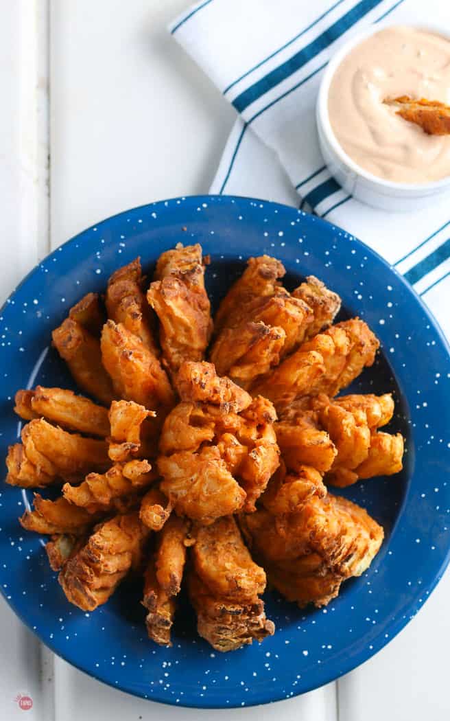 overhead pic of bloomin onion in a blue bowl on white backdrop