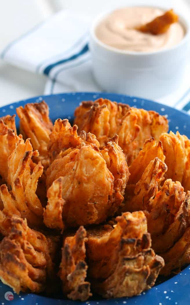 blooming onion in a blue enamel bowl