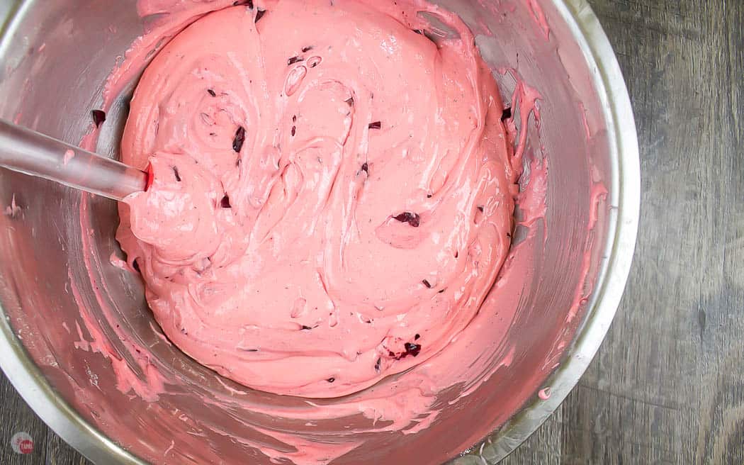 pink cake batter in metal bowl